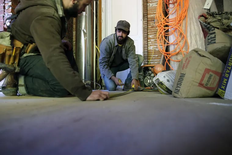 Sampson Smoot, left, and Zach Ogden, right, who will be part of the coop Hivemind Philly, work on an addition to a property on the 4200 block of Regent Square in Philadelphia, PA on October 24, 2018.