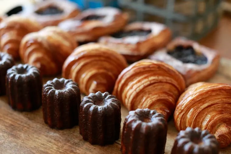Croissants flanked by vanilla bean canele and blueberry tarts at Malvern Buttery.