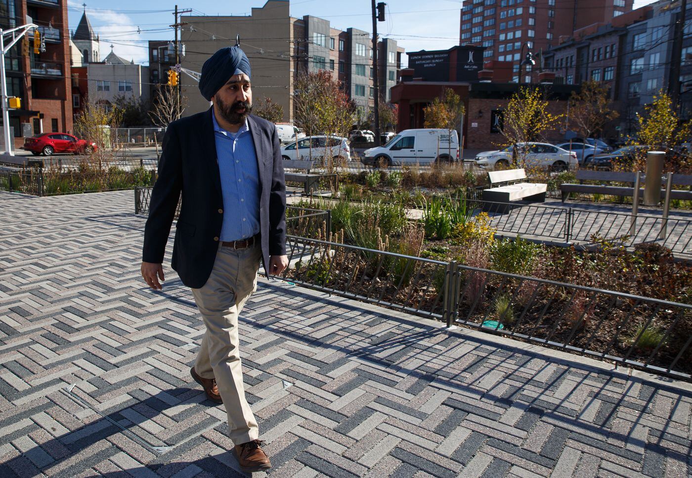 Hoboken Mayor-elect Ravi Bhalla walks through a new park that is an example of open spaces and flood-mitigating projects he sees as crucial to improving the quality of life in the densely populated city.