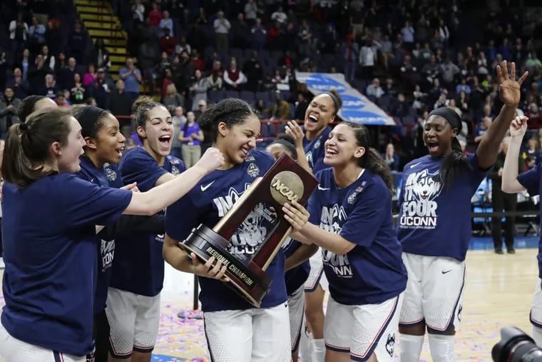 Connecticut’s Gabby Williams (center) celebrates with teammates after their victory over South Carolina.