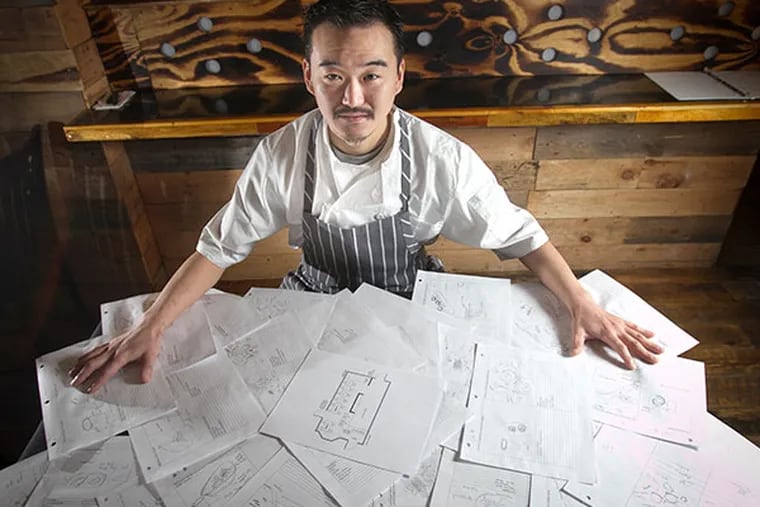 Ryo Igarashi, chef at the soon-to-open Ronin Kitchen, with pages from his culinary sketch book in Philadelphia. ( ALEJANDRO A. ALVAREZ / STAFF PHOTOGRAPHER )