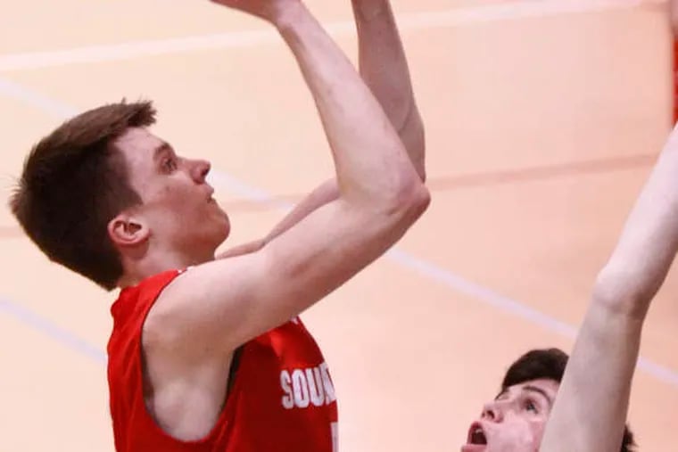 Souderton forward Evan Slone shoots over Judge's Nick Nowack. Slone had 14 points and 11 rebounds as the Indians beat the Crusaders in the Trojan Holiday Classic at Wissahickon. LOU RABITO / Staff