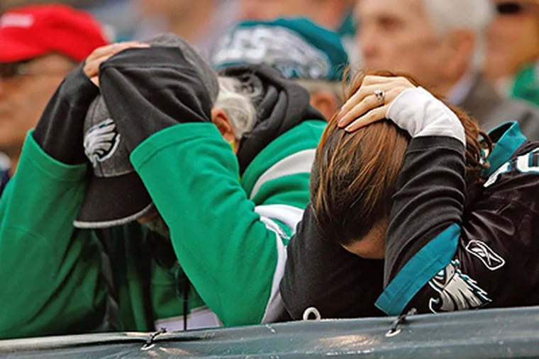 What is it this time? Suffering is a Philadelphia tradition. Here, Eagles fans hang their heads in October 2006 after quarterback Donovan McNabb got carted off the field with a torn-up knee.