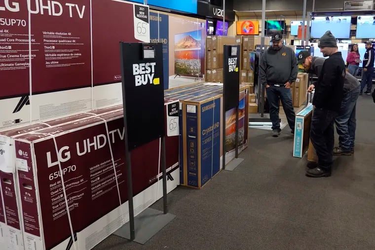 Customers debate on a television selection during a Black Friday sale at Best Buy in Indianapolis.  U.S. consumer prices rose 6.8% in the year ending in November, the fastest pace since 1982.