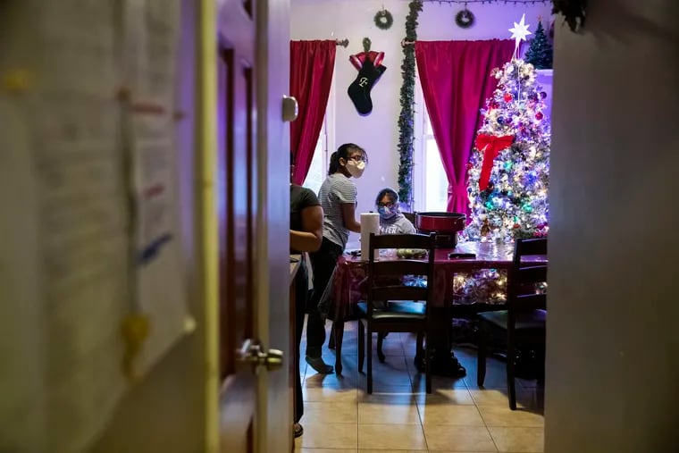 Marcia Larios-Us, 11 and Gabriela Larios-Us, 9, sit in the kitchen at their home in Cliffside Park, N.J. on Thursday, December 10, 2020. In 2019 Juana Us-Perez, 35, was fatally stabbed at her home in Philadelphia, during the early hours of Christmas morning. As the anniversary approaches, her five children are living with their aunt and other relatives in Cliffside Park, N.J.