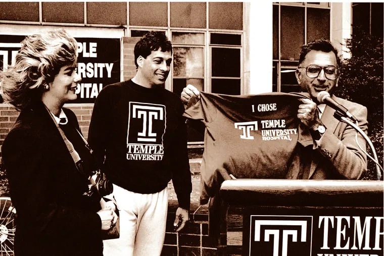 Joe Miceli and his wife, Carol, at Temple University Hospital just before the start of his bike ride, standing next to Temple's president at the time, Peter Liacouras.