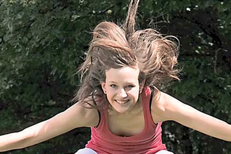 Stock image of a cheerleading girl jumping.