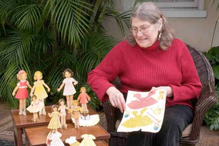 Carlene Bausch Moscatt of Baltimore treasures the paper dolls she received from the du Pontsat Christmas. Her father was a gardener on the estate; her mother was Alice du Pont's maid.
