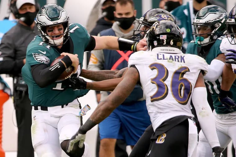 Eagles quarterback Carson Wentz rumbles for 40 yards in the fourth quarter against the Ravens in Sunday's 30-28 loss.