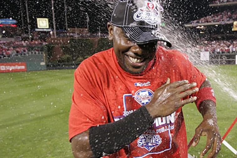 Ryan Howard  gets doused by champagne as he waits to receive the MVP Trophy after the Philadelphia Phillies beat the Los Angeles Dodgers to win the National League Pennant. ( Michael Bryant / Staff Photographer )