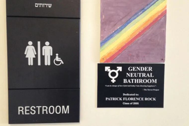 The sign on the gender-neutral bathroom at Jack M. Barrack Hebrew Academy in Bryn Mawr was designed by students, who were inspired by an alumnus to have a dedicated facility.