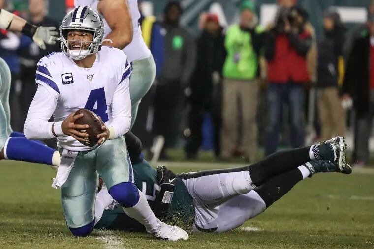 Cowboys quarterback Dak Prescott getting sacked by Eagles defensive end Vinny Curry in last year's game at the Linc.
