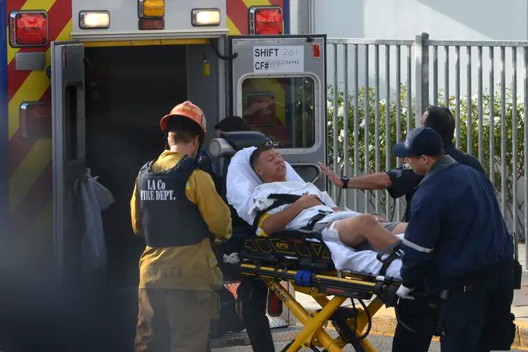 Medical personnel load an injured person into an ambulance outside Saugus High School in Santa Clarita, Calif., after a student gunman opened fire at the school on Thursday.