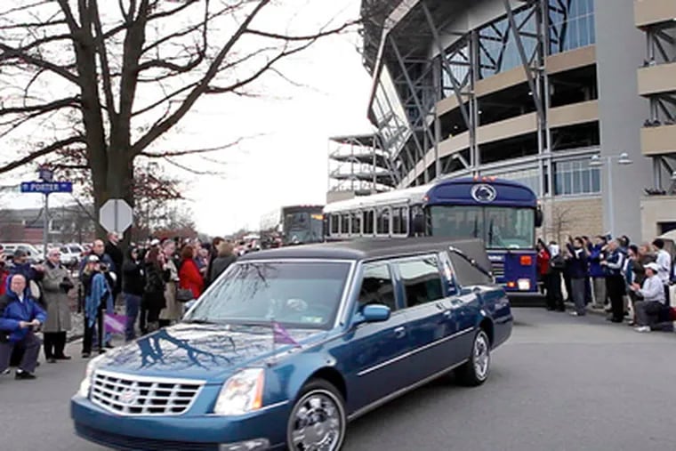 The hearse carrying the body of Joe Paterno passes Beaver Stadium. Happy Valley has been forever altered by the coach's tragic fall and death. (Laurence Kesterson / Staff Photographer)