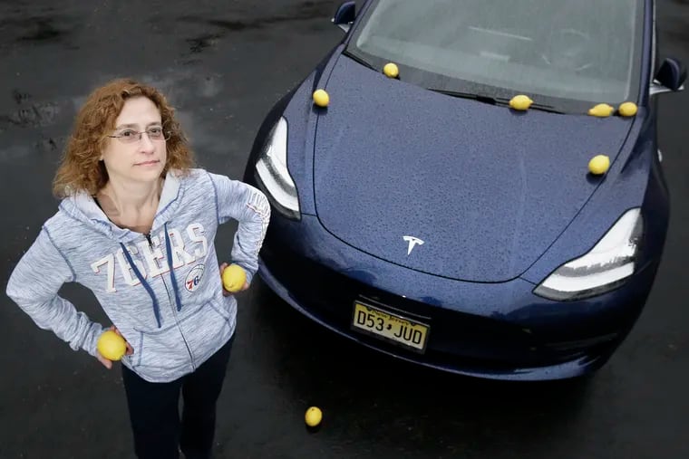 Jennifer Salvage, her 2018 Tesla Model 3 and some lemons were photographed at her Medford, N.J. home on April 5, 2019. Jennifer and her husband Jeff Salvage have had several issues with the 2018 Tesla Model 3, including the inability to connect a cell phone to the car. Tesla blamed the phone.