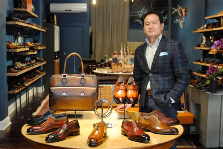 Tung To poses with some of his favorite pairs of shoes at his shop, which sells fine-quality leather dress shoes and boots as well as causal footwear for men. (GABRIELA BARRANTES / STAFF PHOTOGRAPHER)