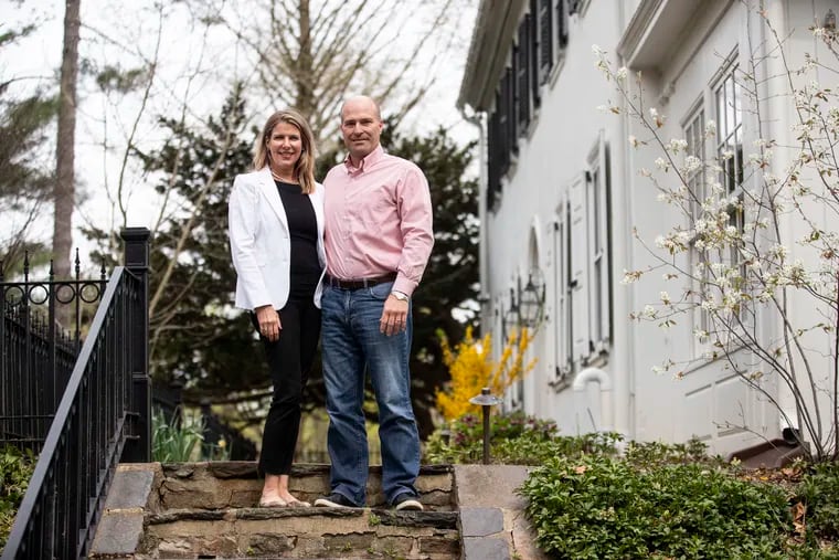 Laura and Doug Yeakle outside of their home in Newtown Square. The house "old and dated, but it had great bones, and the property is private with a tremendous amount of trees and unique plantings,” Doug said.
