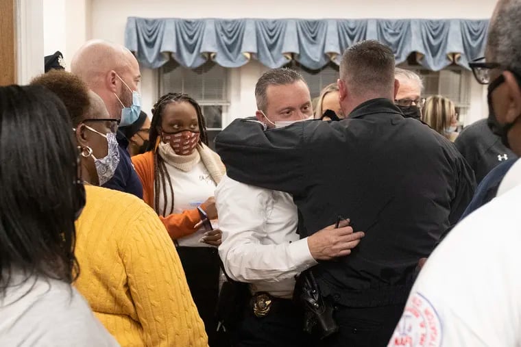 Yeadon Police Chief Anthony Paparo hugs a police officer as he leaves Yeadon Borough Council Chambers.  The council  voted 4-3 Thursday night to fire Paparo.