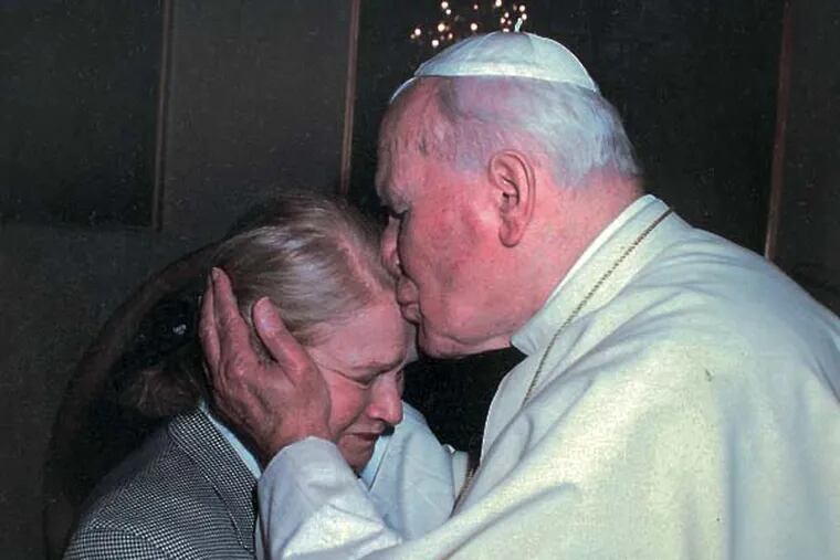 This is a copy of a photo that Lena Allen-Shore has of Pope John Paul II, right, giving Lena Allen-Shore, left,  a kiss on the head during a Vatican visit. We mark the day of Pope John Paul's canonization (a Sunday) by visiting with Lena Allen-Shore, a Polish-Jewish Philadelphia woman who befriended JP soon after his election. During World War II she vowed to devote her life to interfaith harmony if she survived. She and JP corresponded fairly frequently, and she visited him seven or eight times at the Vatican, where he once sang happy birthday to her   04/10/2014  ( MICHAEL BRYANT / Staff Photographer )