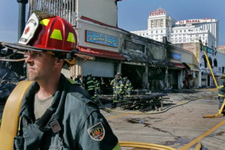 Atlantic City firefighters finish their work extinguishing a fire that destroyed five stores in a single building along the Boardwalk and damaged the Casino Control Commission's offices.