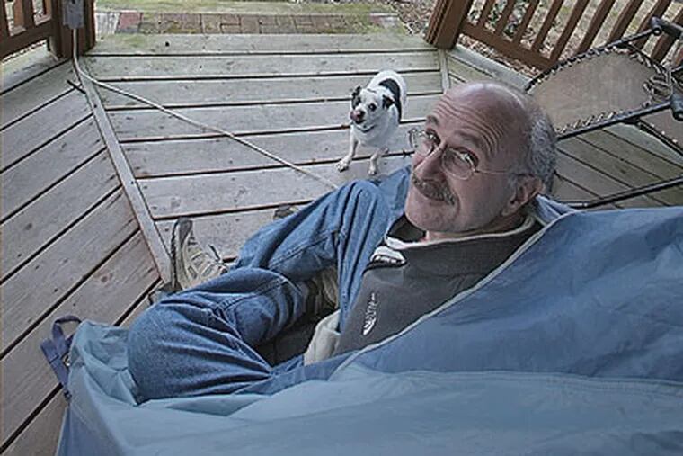 Dr. Gerald Feigin, Camden and Gloucester County medical examiner,  had been living in a tent in his backyard because he becomes violently ill inside his home. (David M Warren / Staff Photographer)