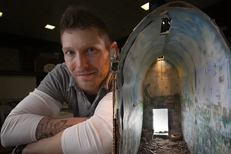 Jesse Krimes, artist created a 39-panel mural out of bedsheets during his incarceration in the federal system. Photograph of Krimes with miniature model of the installation he will display at Eastern State Penitentiary. (ALEJANDRO A. ALVAREZ / Staff Photographer )