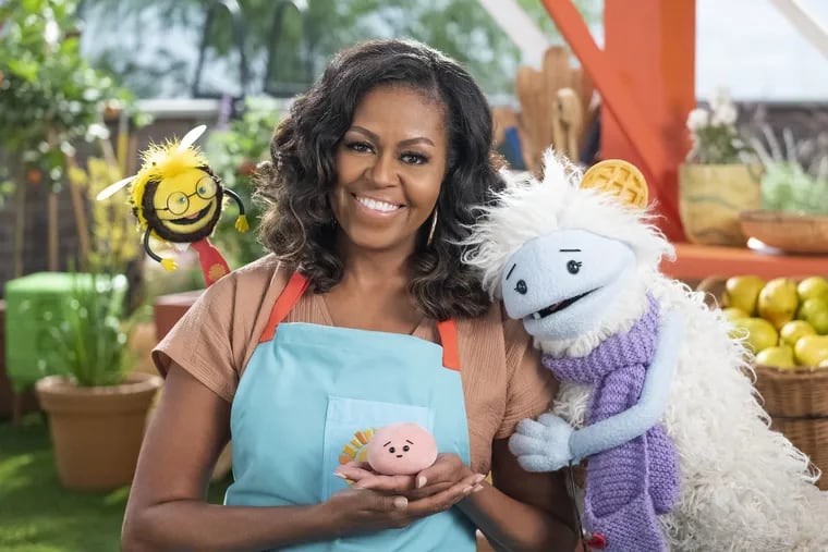 Michelle Obama with Mochi (in her palm), Waffles (right), and Busy the bee (left).