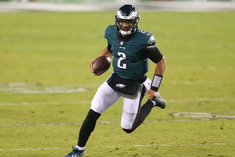 Eagles quarterback Jalen Hurts runs with the football during the second quarter against the Washington Football Team on Sunday, January 3, 2021 in Philadelphia.