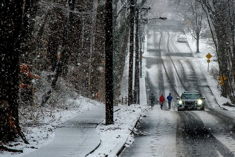 Snow falls along Centre Street in Haddonfield Sunday as a fast-moving storm moves through the Philadelphia region. Forecasters said up to 4 inches were expected before the storm ends by midafternoon.