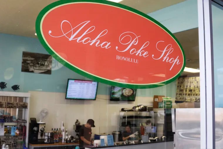 This Tuesday, April 16, 2019, photo shows Aloha Poke Shop, a store in Honolulu that received a letter from Chicago-based Aloha Poke Co. saying the Illinois company had trademarked "Aloha Poke" and the Hawaii company would need to change its name. Hawaii lawmakers are considering adopting a resolution calling for the creation of legal protections for Native Hawaiian cultural intellectual property. (AP Photo/Audrey McAvoy)