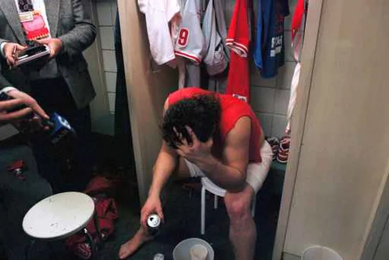 Phillies closer Mitch Williams sat in front of his locker, beer in one hand and his head in the other, after the Phillies lost the sixth and deciding game of the 1993 World Series to the Toronto Blue Jays.