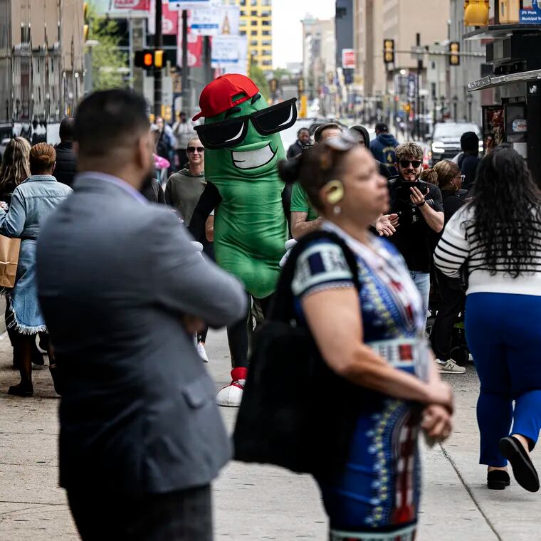 Dilly the pickle walks in Center City. The big pickle is the mascot for the Big Dill carnival party events, soon to host a big gathering in the city.