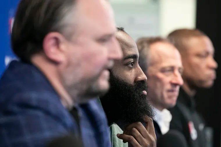 James Harden sits between Daryl Morey (left), Josh Harris, and Doc Rivers (far right) during a press conference formally introducing both him and Paul Millsap on Feb. 15, 2022.