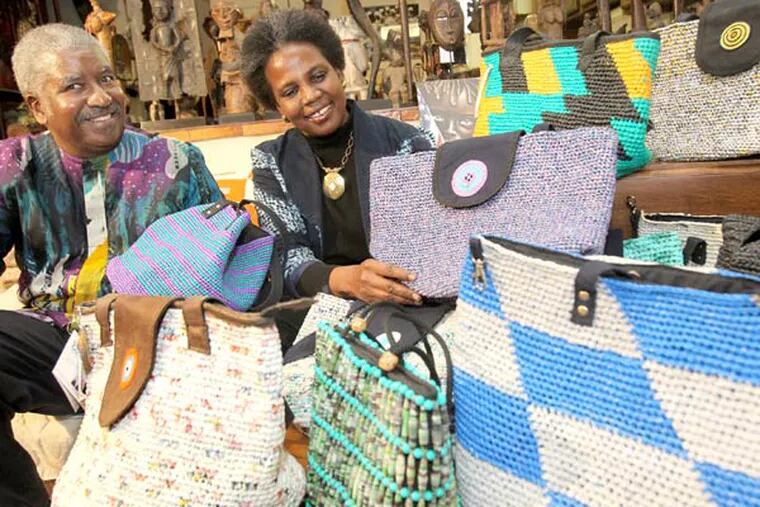 Herman and Lucy Bigham display some of the handbags made from plastic shopping bags. (Charles Fox / Staff Photographer)