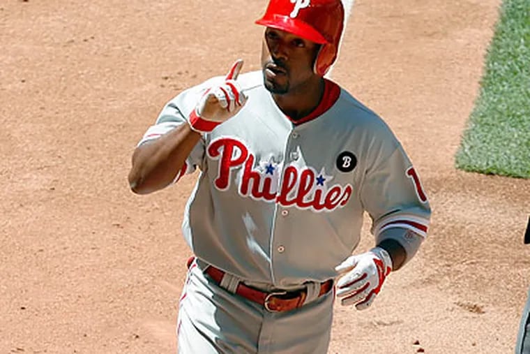 Jimmy Rollins celebrates after hitting one of the Phillies' three home runs against the Diamondbacks. (Ross D. Franklin/AP)