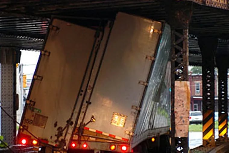 The math came up negative as this 13-foot-plus tractor-trailer rig got stuck underneath the 12-foot, 9-inch train trestle on Haddon Avenue in Camden. The independent trucker from San Bernadino, Calif., was carrying 7,000 pounds of Frito Lay snacks when the accident happened at 3:30 this morning.
