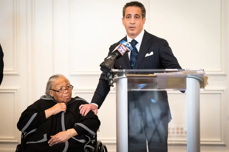 Susie Carter, the sister of Alexander McClay Williams, speaks with Joseph Marrone during a news conference on Monday. Marrone has filed a federal lawsuit on Carter's behalf, alleging that Williams was coerced into confessing to a murder that prosecutors in Delaware County now say he did not commit.