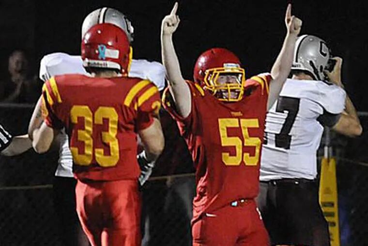Haverford's Matt Skurka (55) and his teammates celebrate after
recovering a fumble by Conestoga. (Ron Tarver/Staff Photographer)