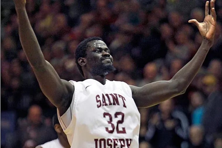St. Josephs' Papa Ndao (32) celebrates after scoring a foul shot
against Massachusetts in the final seconds of the second half of an
NCAA college basketball game, Saturday, Feb. 1, 2014, in Philadelphia.
 St. Josephs won 73-68.  (AP Photo/Laurence Kesterson)