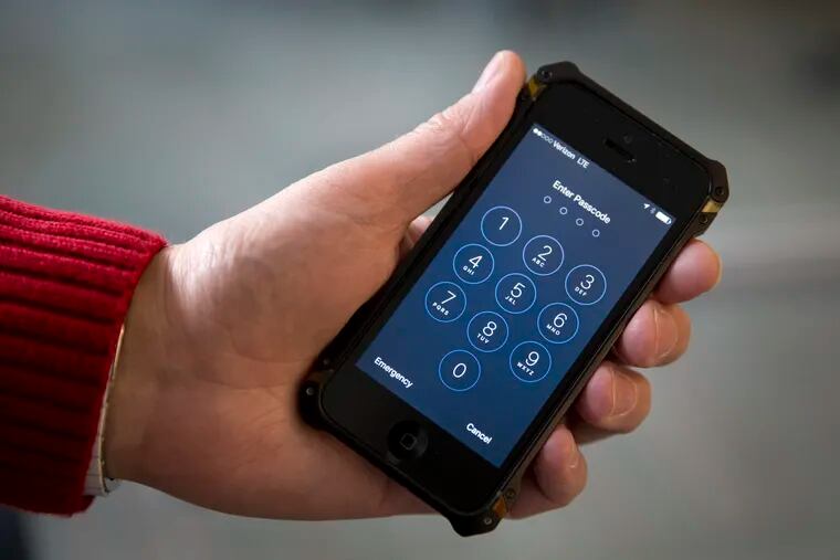 FILE - In this Feb. 17, 2016, file photo an iPhone is seen in Washington. A new watchdog report has found that U.S. Customs and Border Protection officers are searching the electronic devices of travelers more often and did not always follow proper protocol. (AP Photo/Carolyn Kaster, File)