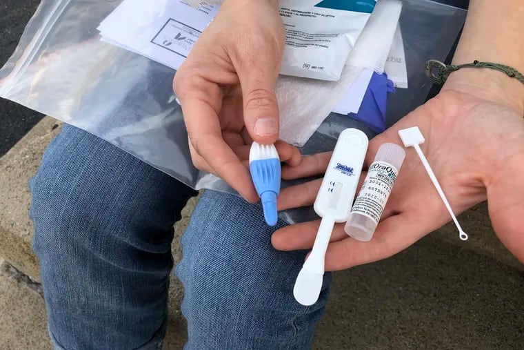 In this 2021 photo, a West Virginia addiction outreach worker is seen holding a HIV test kit similar to the ones Philadelphia community groups will be handing out as part of a new partnership.