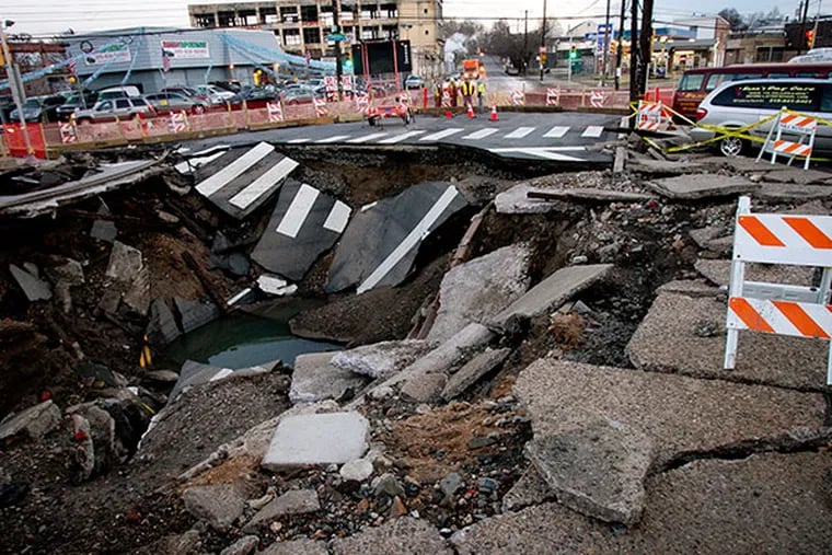 The water main break at intersection of Torresdale and Frankford Ave left a gaint crater in the street, seen here on Tuesday, December 24, 2013. ( ALEJANDRO A. ALVAREZ / STAFF PHOTOGRAPHER )