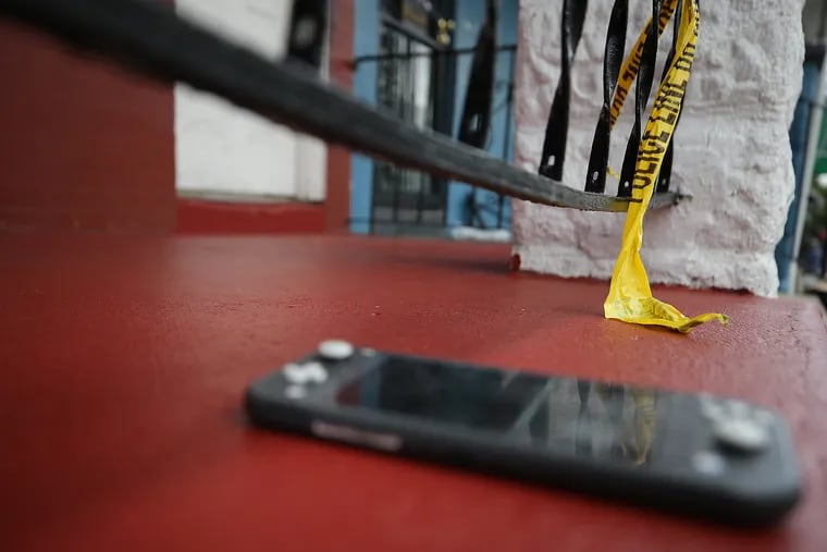 A video game controller and crime tape sits on a porch on the 200 block of N. Simpson Street in Philadelphia, Pa. on August 2, 2020. The items were near the scene of a shooting on Saturday. A 7-year-old child playing on his porch was caught in the crossfire.