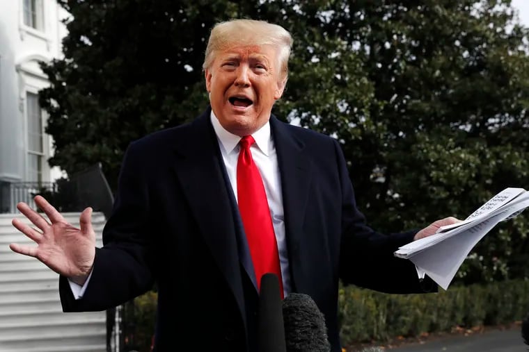 President Donald Trump holds handwritten notes as he speaks to the media about the House Intelligence Committee testimony of U.S. Ambassador to the European Union Gordon Sondland, Wednesday, Nov. 20, 2019, as Trump leaves the White House in Washington.