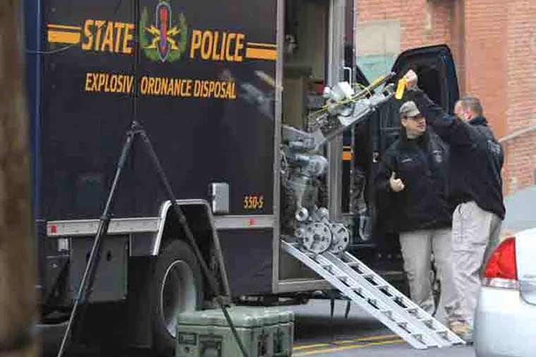Officers unload a bomb disposal robot to check the parking garage on E. 5th St as part of the investigation of a shooting in the lobby this morning at the New Castle County Courthouse, Wilmington, Delaware, February 11, 2013.  ( DAVID M WARREN / Staff Photographer )