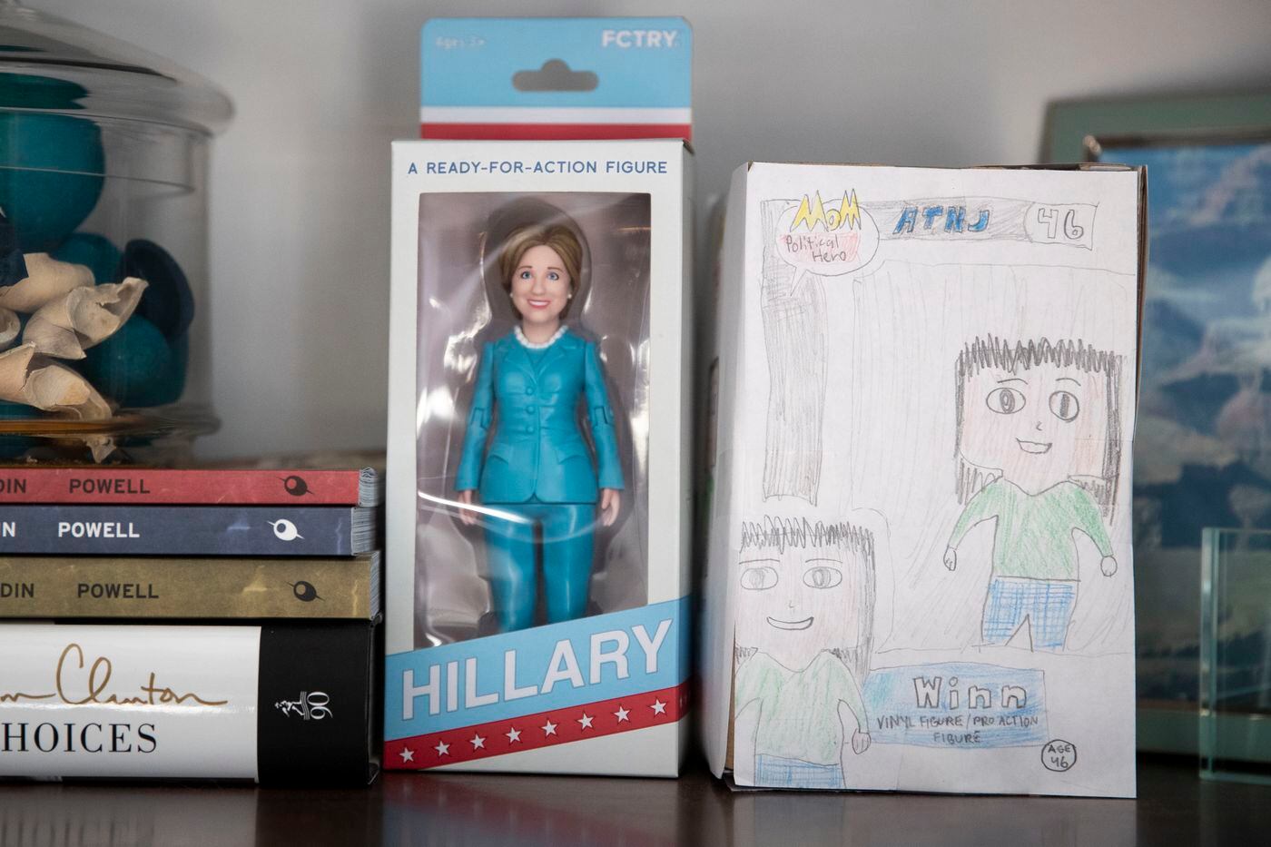 A Hillary Clinton action figure stands next to a gift from Uyen "Winn" Khuong's children, a homemade action figure of "Political Hero" Winn, at her home in Madison, N.J. 