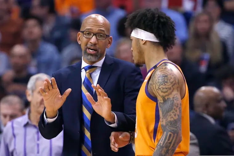 Suns coach Monty Williams (left) talks with forward Kelly Oubre Jr. Williams hired Kevin Young as his assistant.