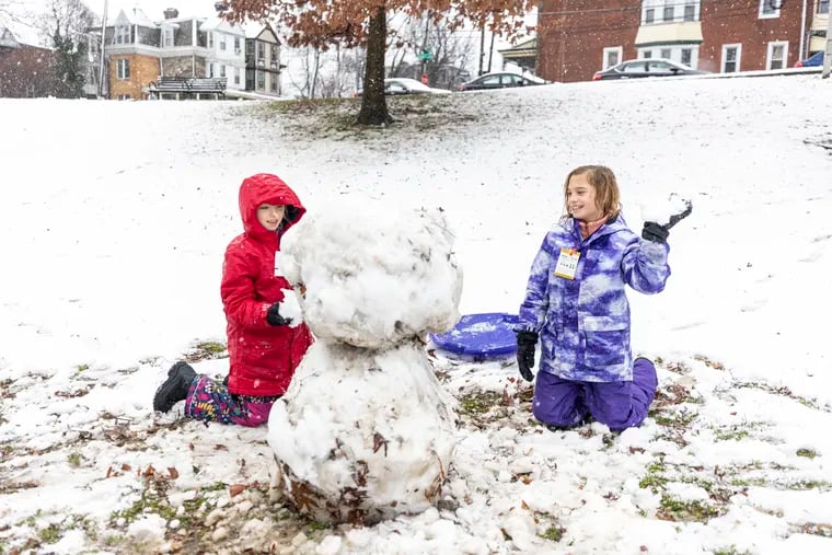 Mira Brickman, 9, (right), and Lilly Brickman, 9, are out making a snowman at Clark Park on Tuesday. It hasn't been the best of times for snowmen.