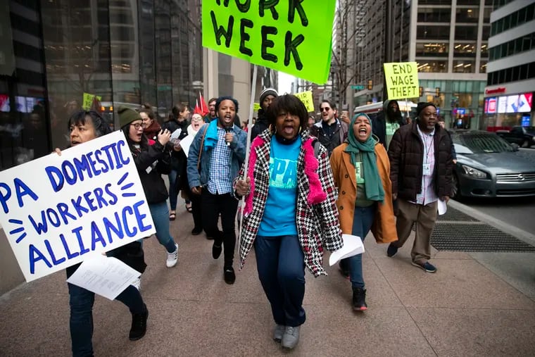(center) Willamae McCullough, a member of One Pennsylvania, chants as she marches down Market Street towards Philadelphia City Hall for a press conference in Philadelphia, Pa. on Wednesday, February 12, 2020. The Coalition to Respect Every Worker (CREW) marched in support of stronger labor enforcement in city government.