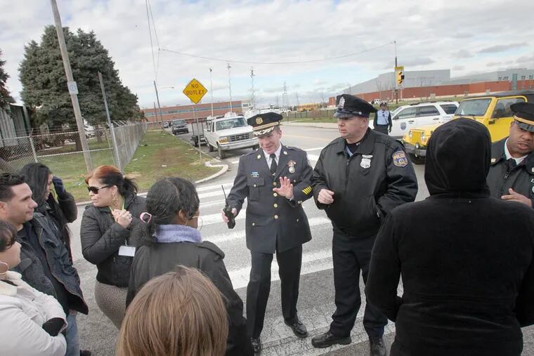 Chief Inspector Dennis Wilson address parents gathered at the edge of school campus with details on investigation inside Fels High School. ( ALEJANDRO A. ALVAREZ / STAFF PHOTOGRAPHER )